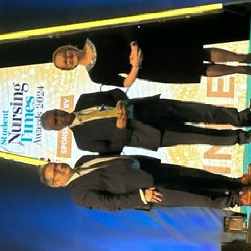 Mike Anjoyeb onstage receiving award