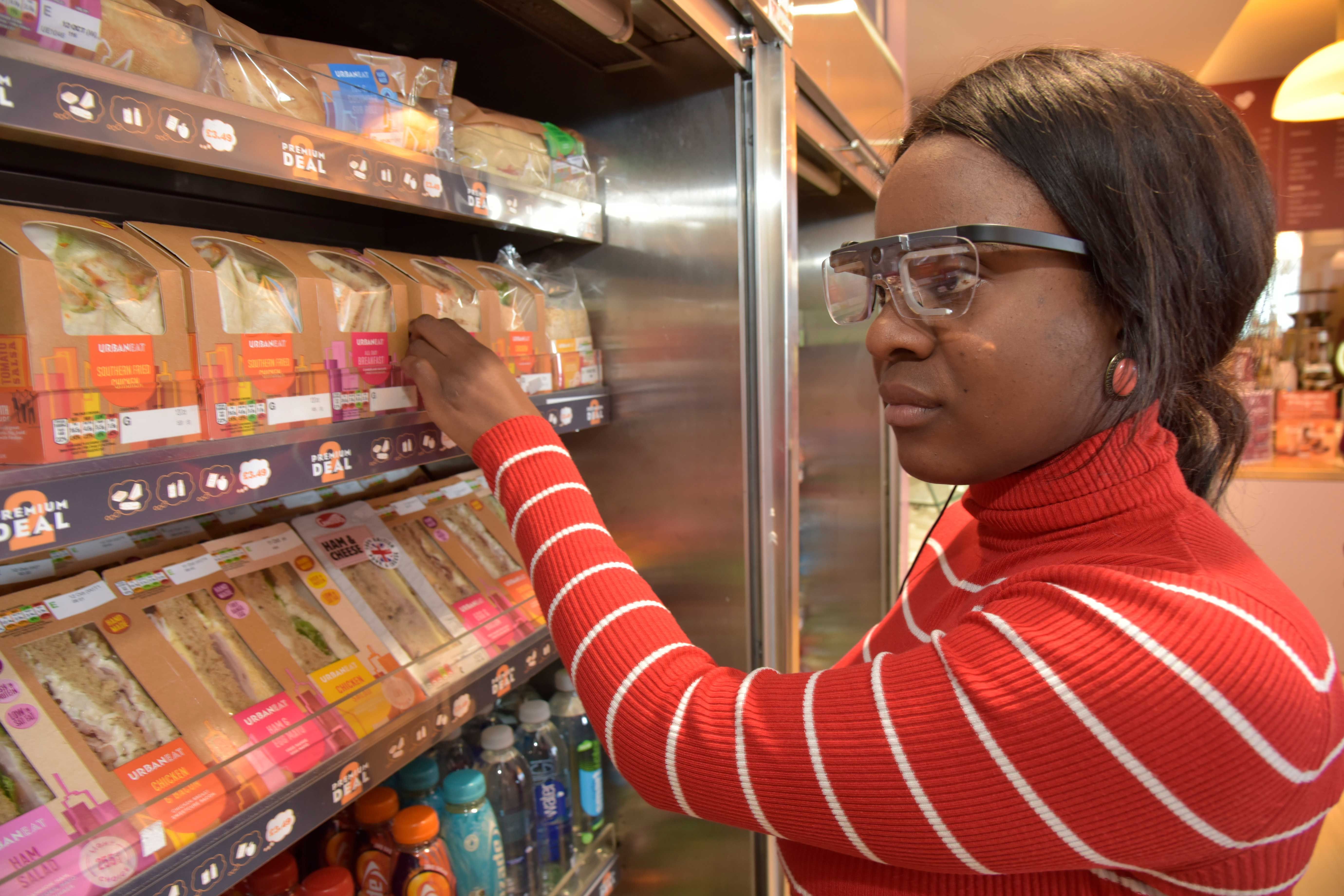 Female student wearing eye tracker and looking at food counter