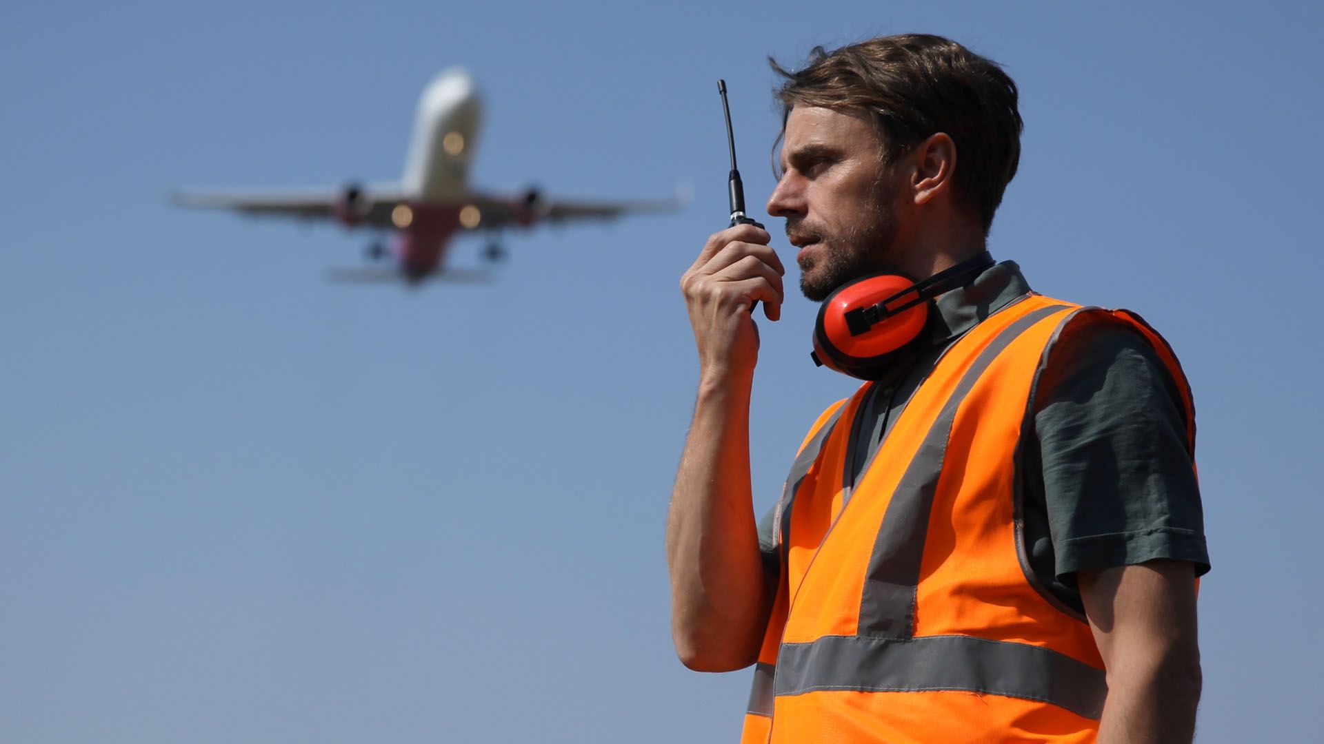 Aviation man stood with plane in background