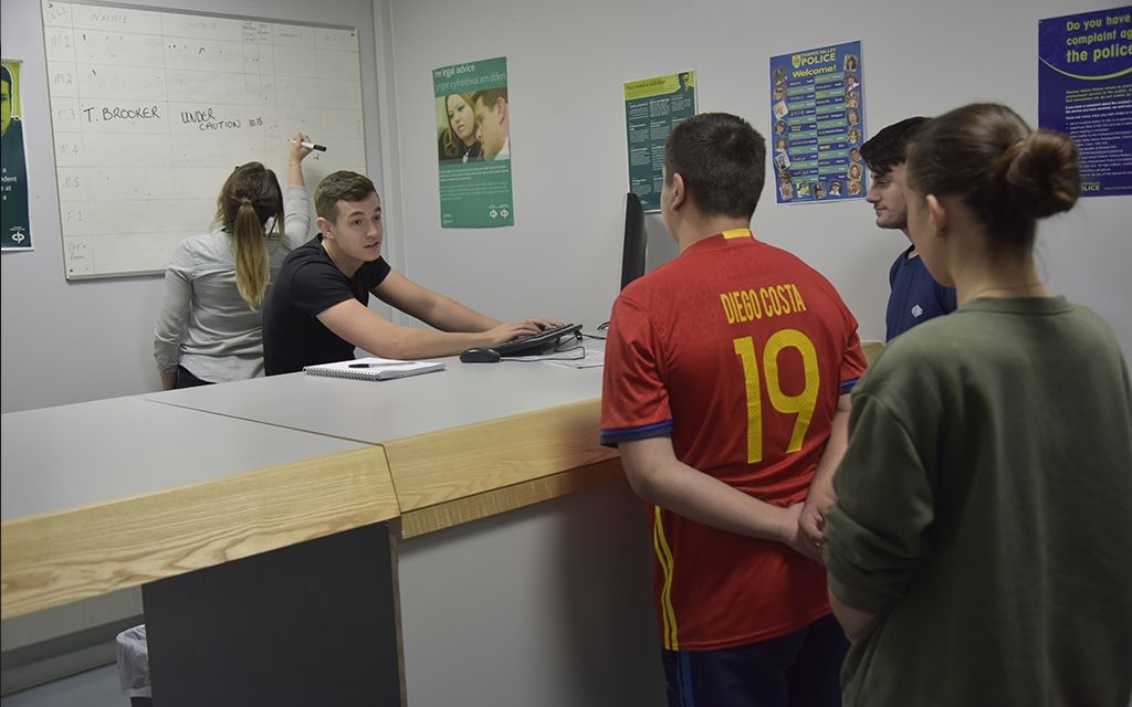 Man being handed in to a police station 