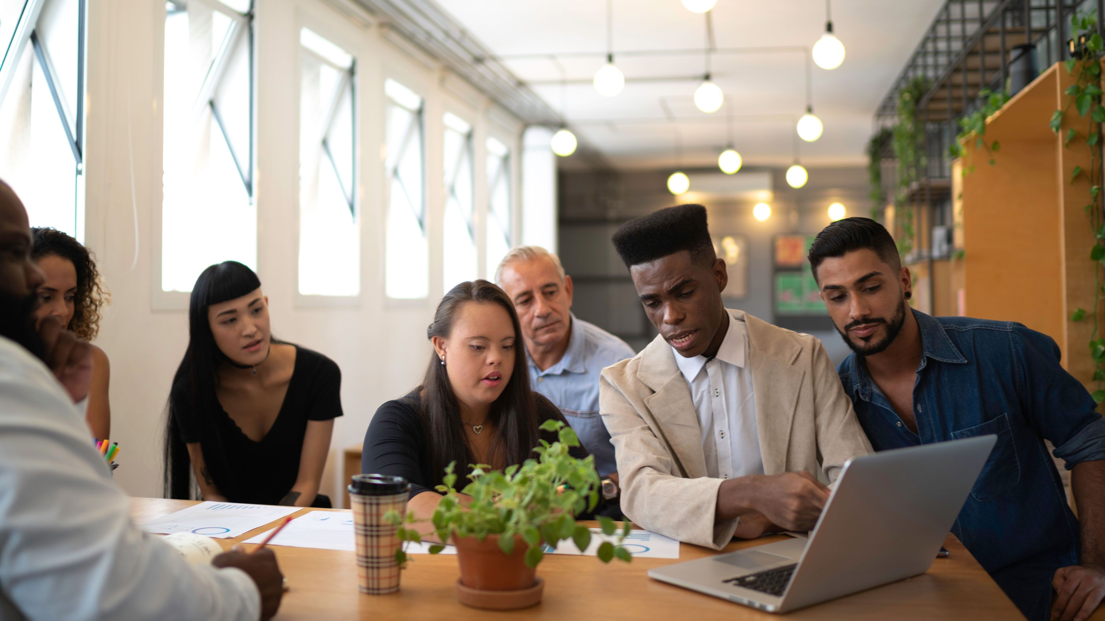 selection of students from many cultures looking at a laptop