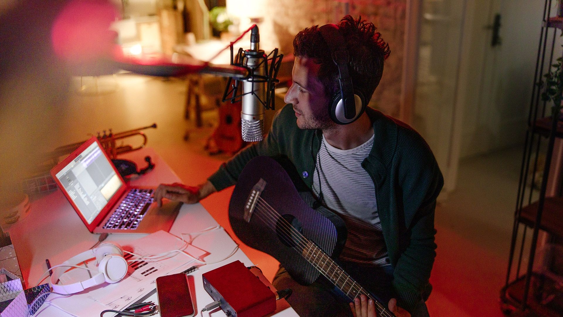 Source Young musician making music in home music studio