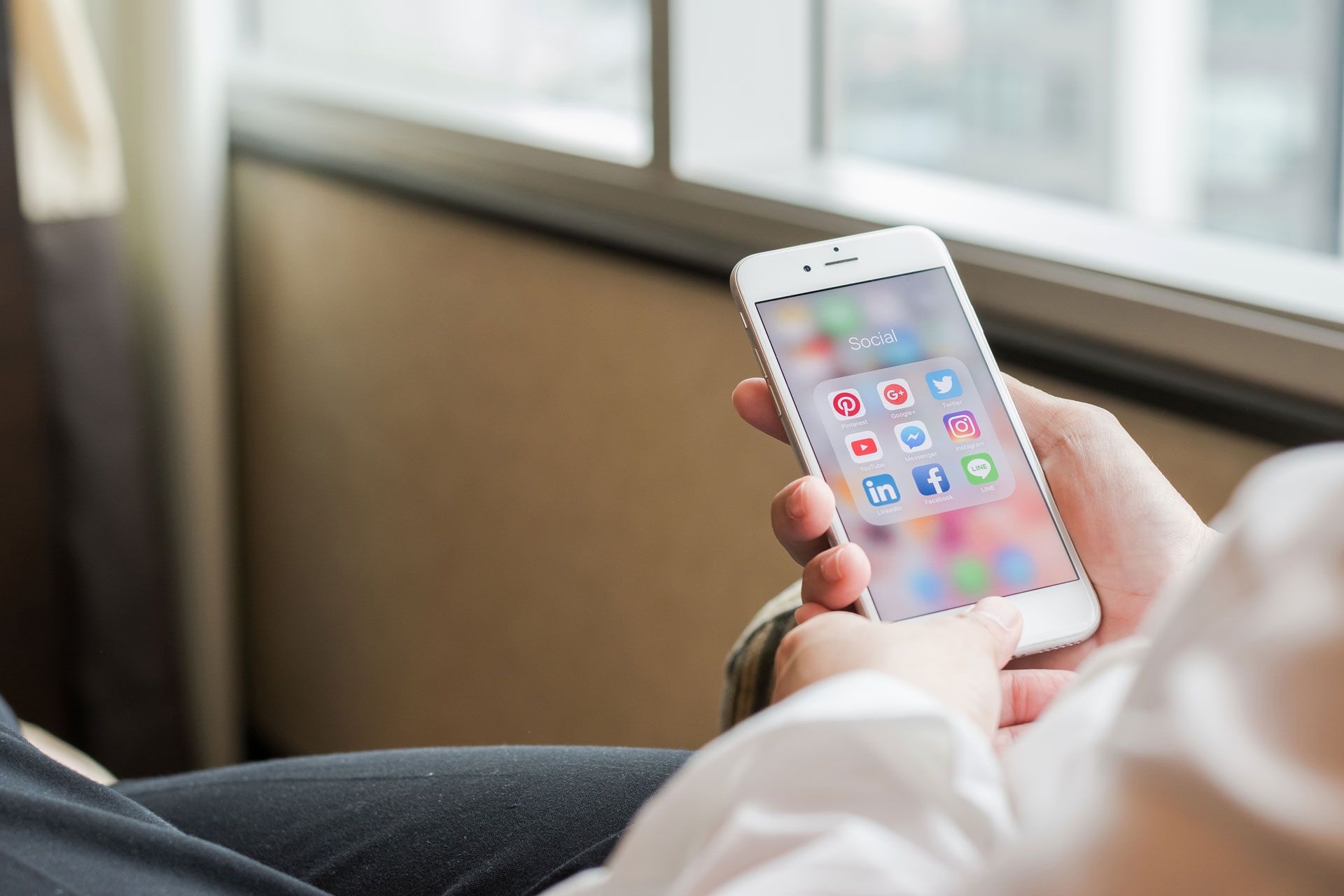 Person on Iphone with social media page open