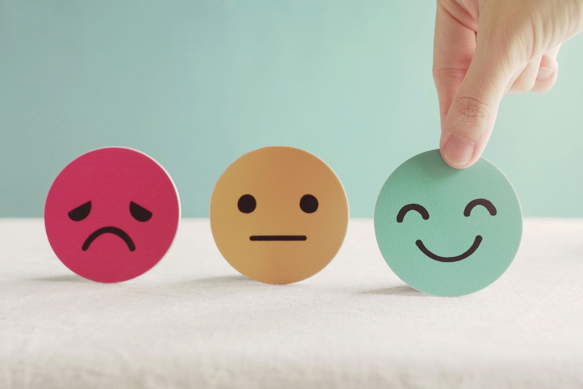 Three faces to show different emotion - mental health