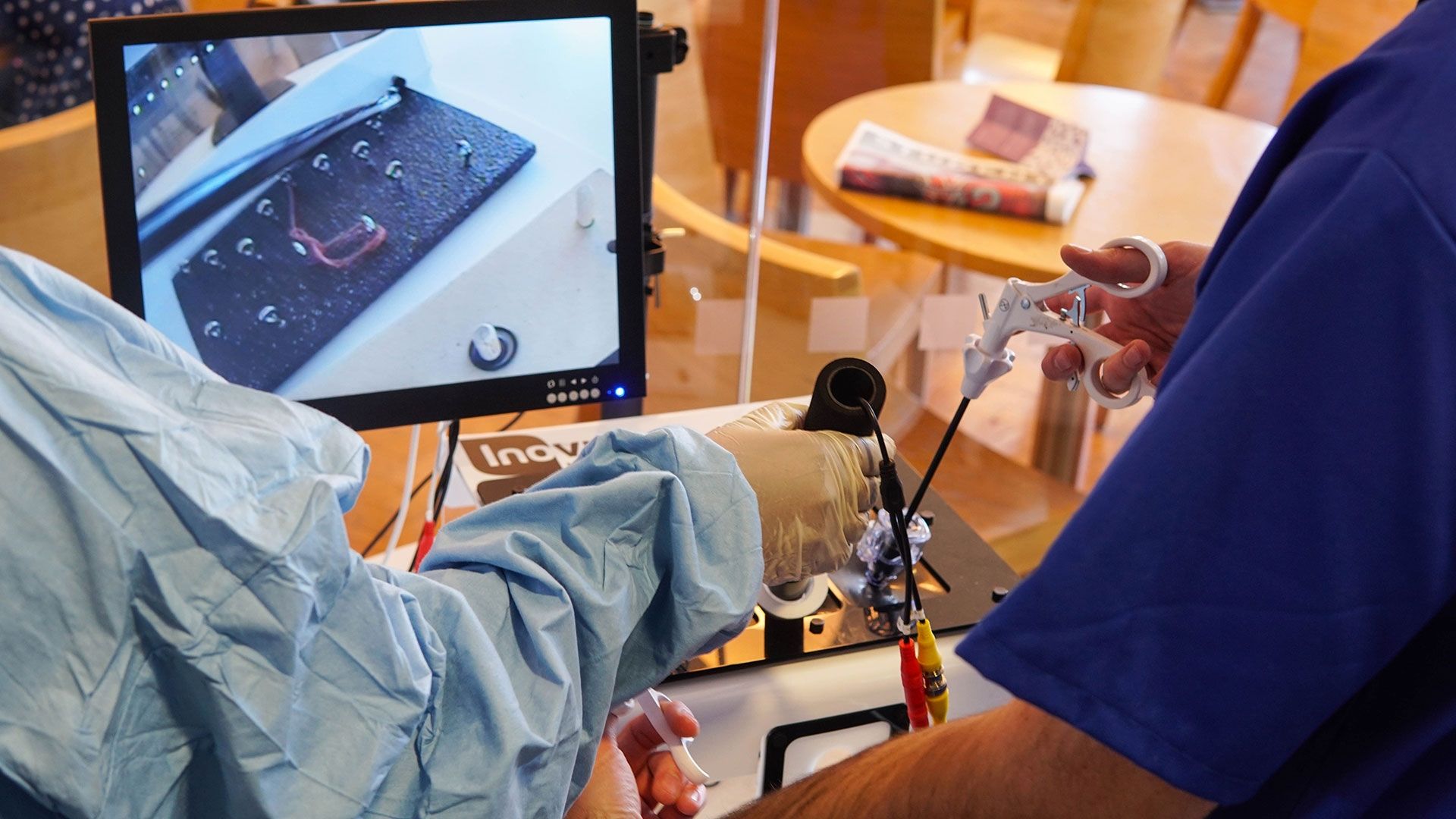 Two students practising Key hole surgery 