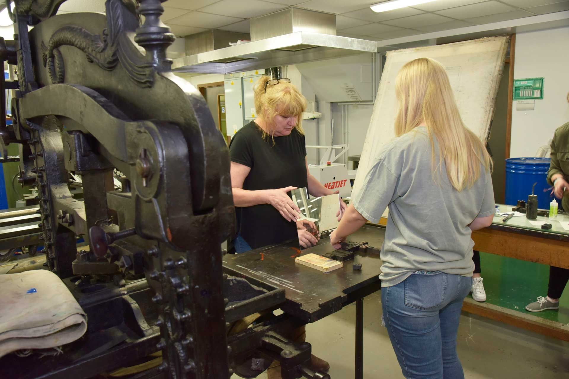 Two females using Printing press machine at BNU