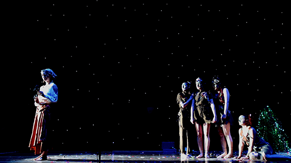 Five performing arts students on stage mid performance