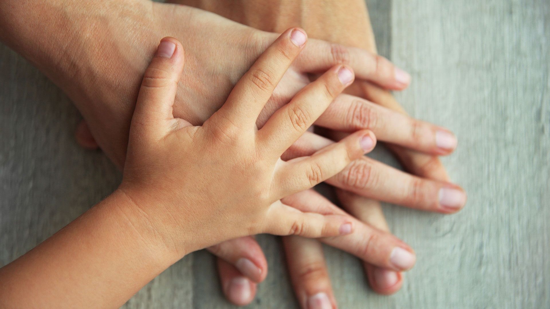 Three white hands on top of each other