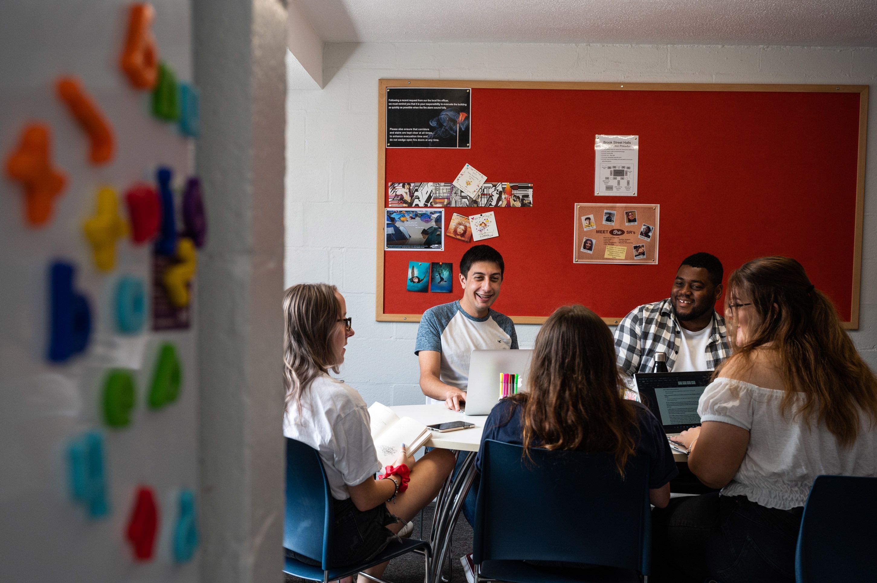 Group of students around kitchen table in Brook Street accommodation