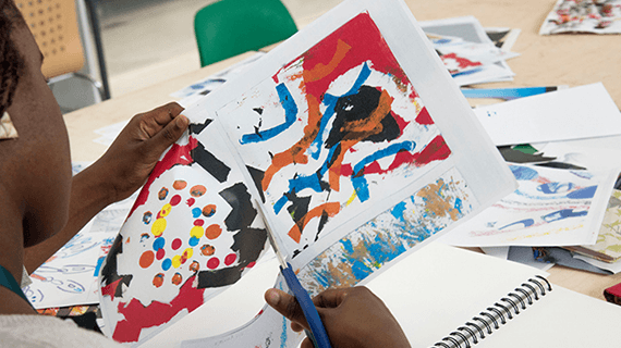 A female student cutting through paper