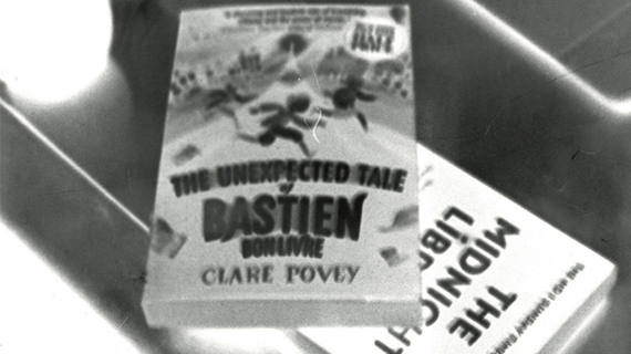 Two books stacked up on top of one another on a table