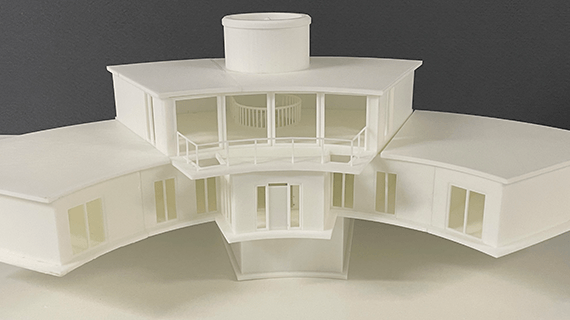 A 3D printed model of a two story building in a semi circle shape