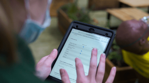 A student using their personal issue ipad to complete a simulated patient record