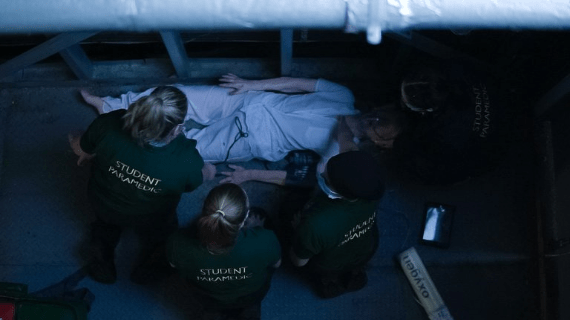 A team of students treat an elderly female (realistic manikin) following a fall