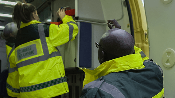 Two students getting equipment from one of our simulation ambulances