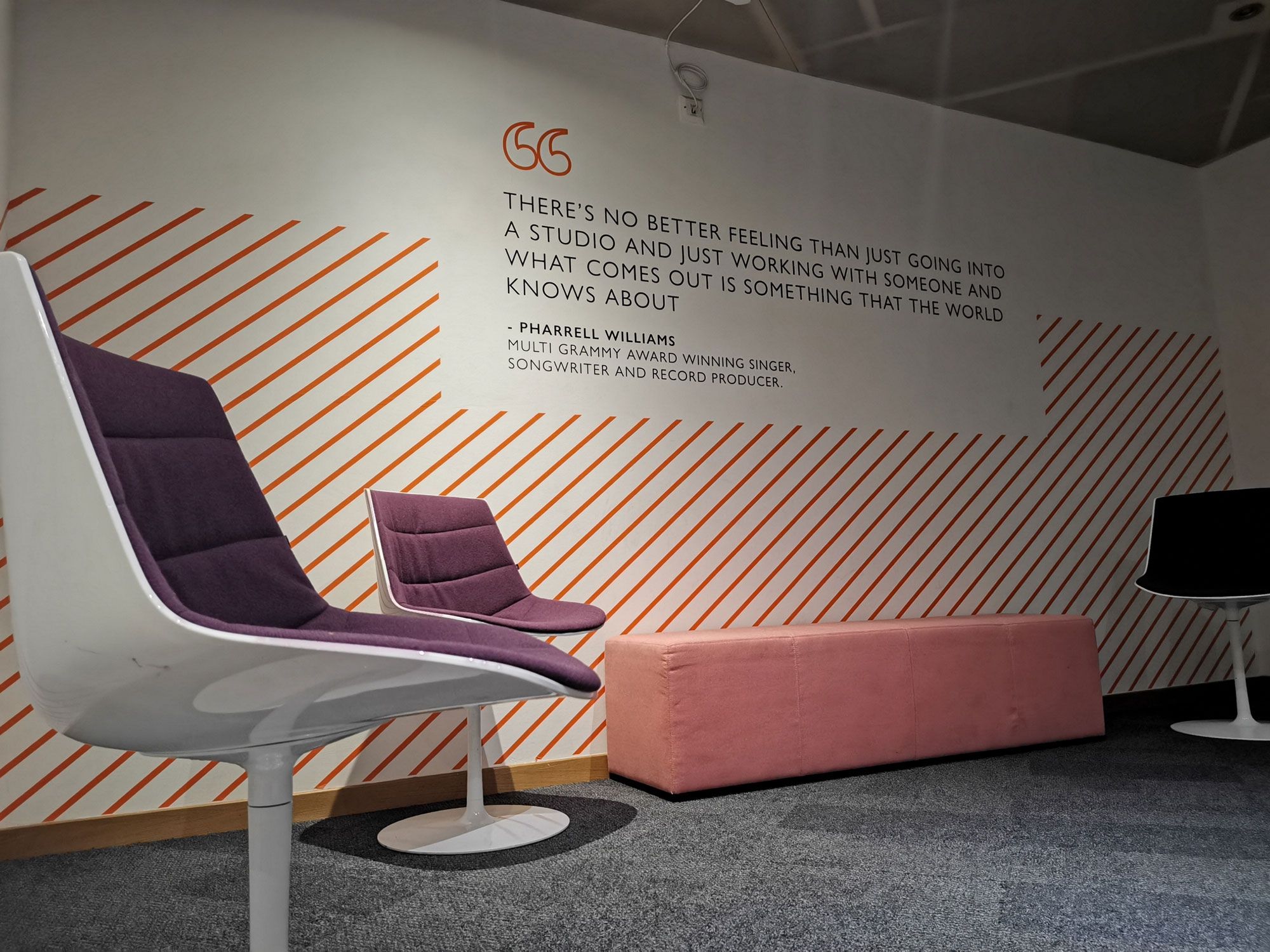 chairs on a stage with quote on wall in the background