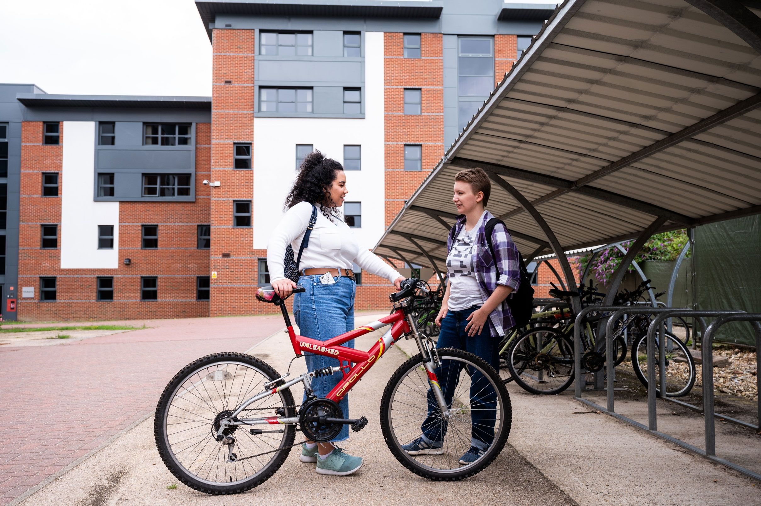 Two  female students talking at the bicycle racks at Hughenden accommodation