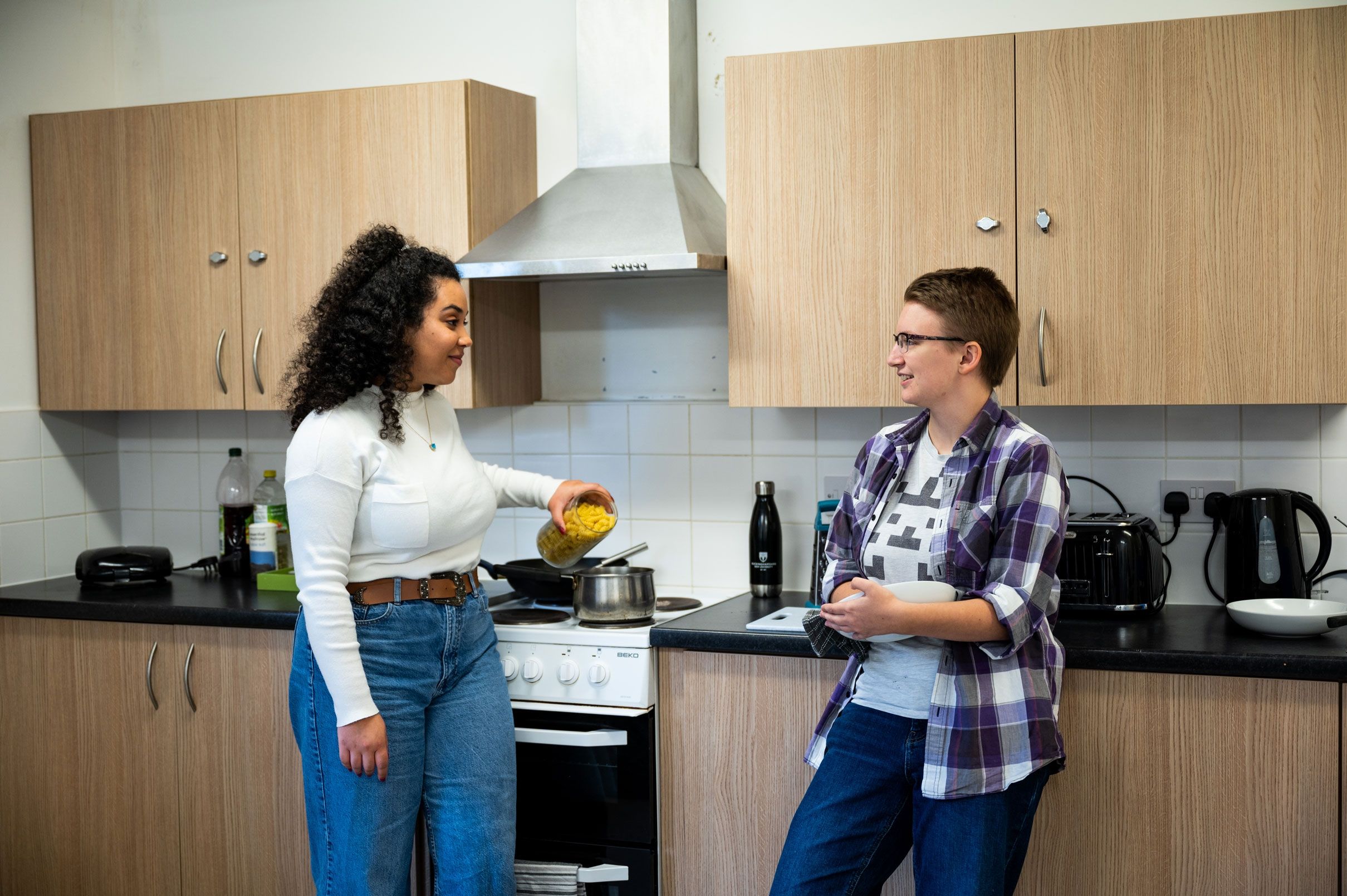 Two students cooking at Hughenden accommodation's shared kitchen