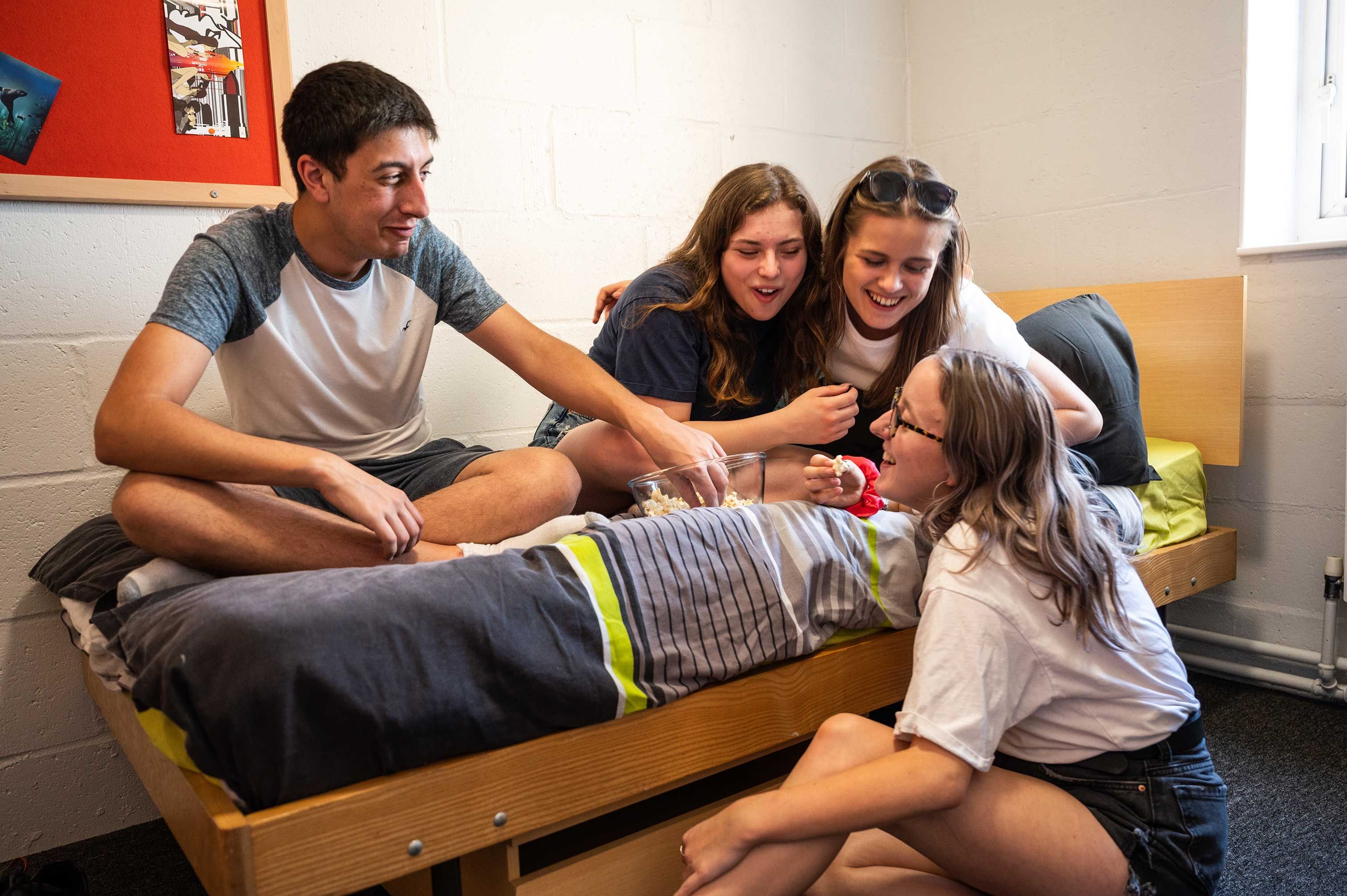 4 students eating popcorn and socialising in a Brook Street bedroom