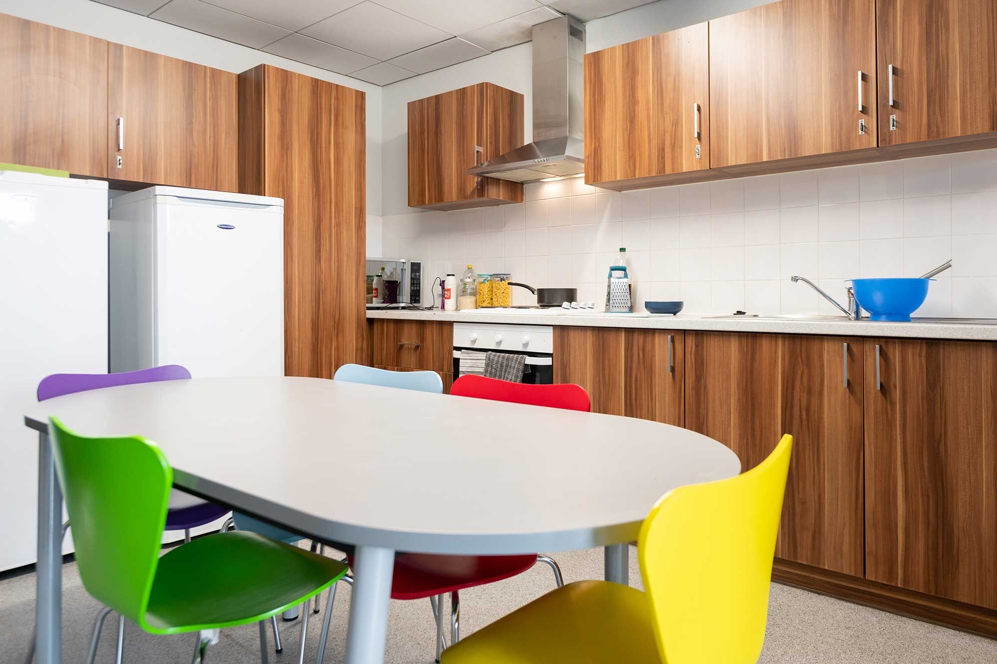 Windsor House kitchen, including table, chairs, fridge, cooker, microwave