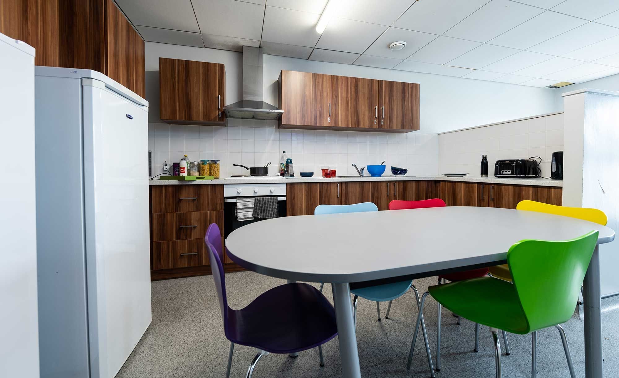 Windsor House kitchen, including table, chairs, fridge, cooker, sink, toaster, kettle