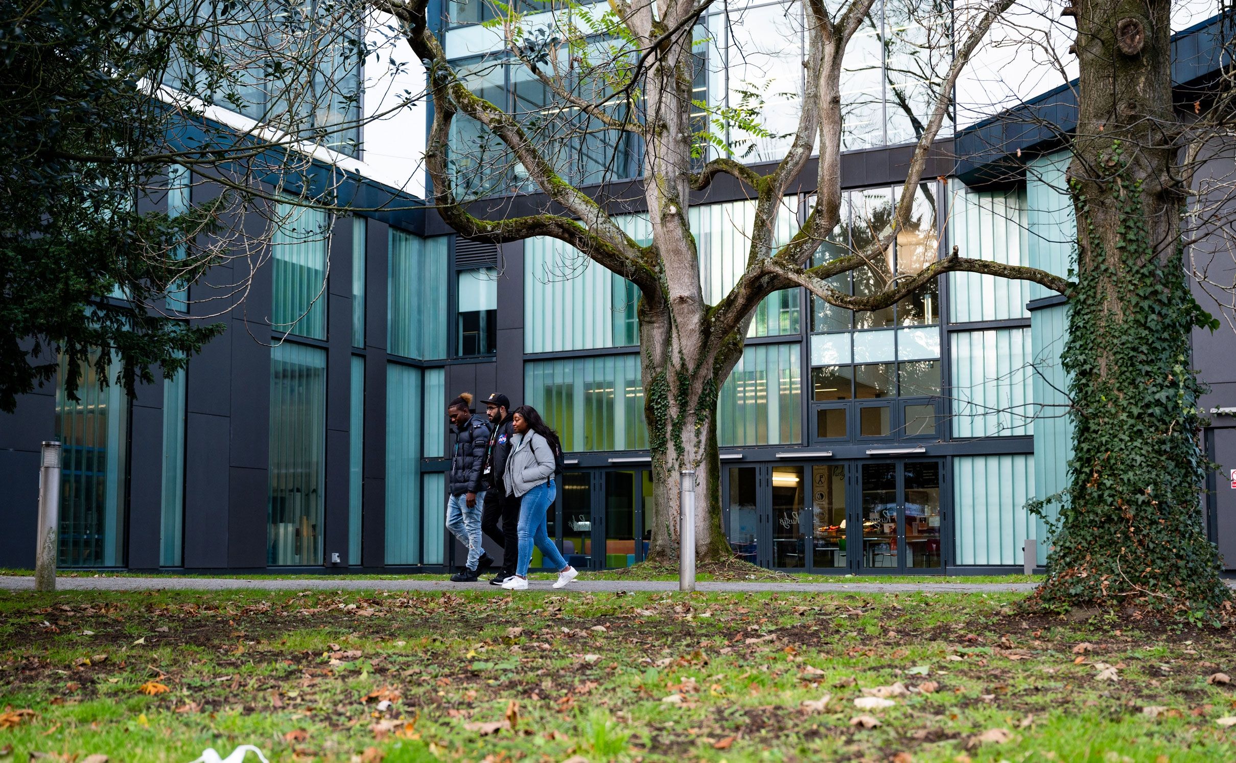 Group of three students walking outside High Wycombe campus