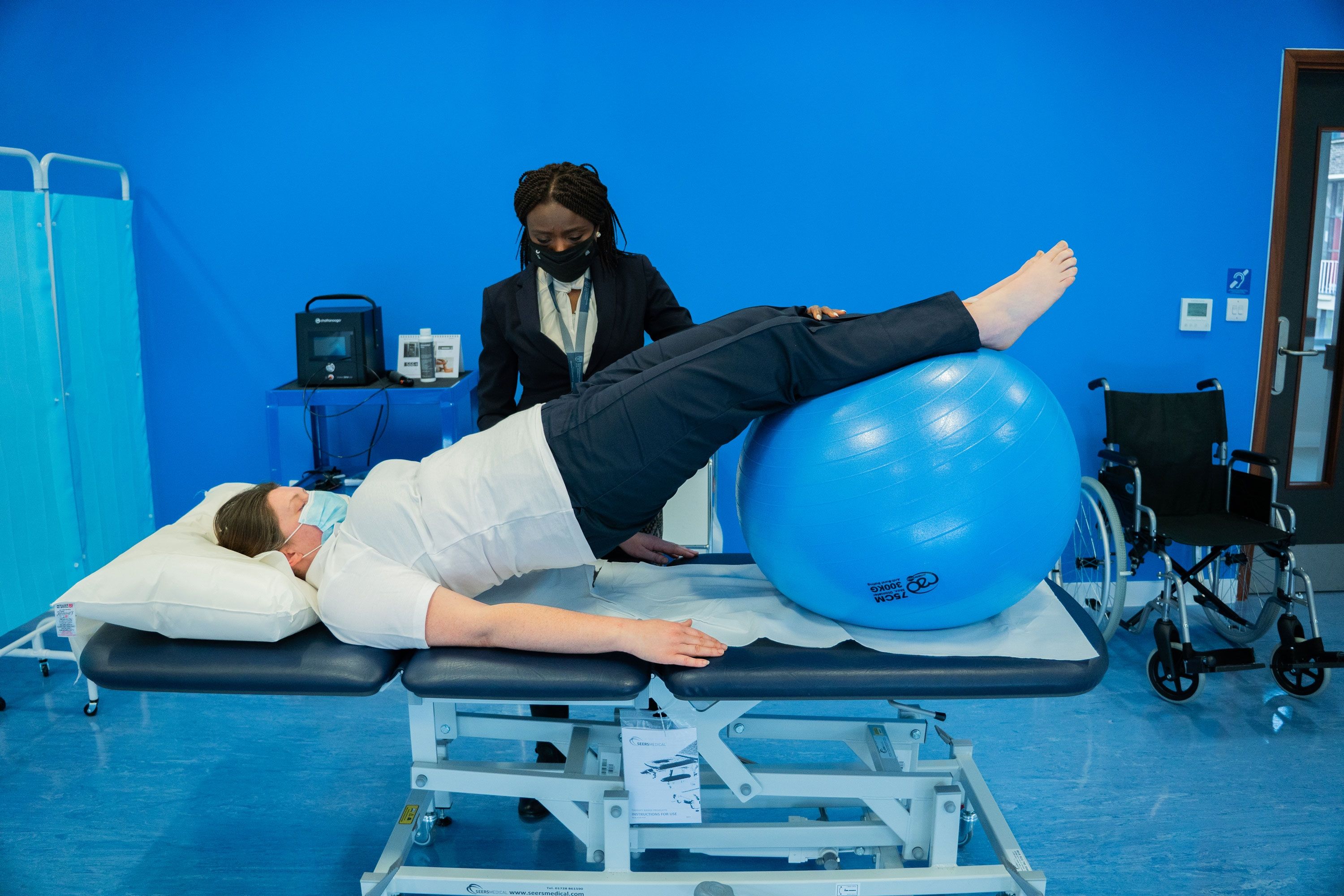man and woman exercising in physiotherapy