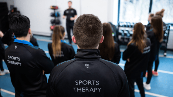 A Sports Therapy class looking towards the teacher.