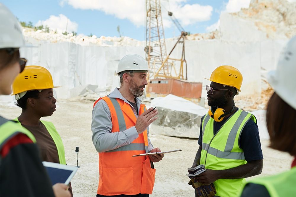 construction workers in conversation in a quarry