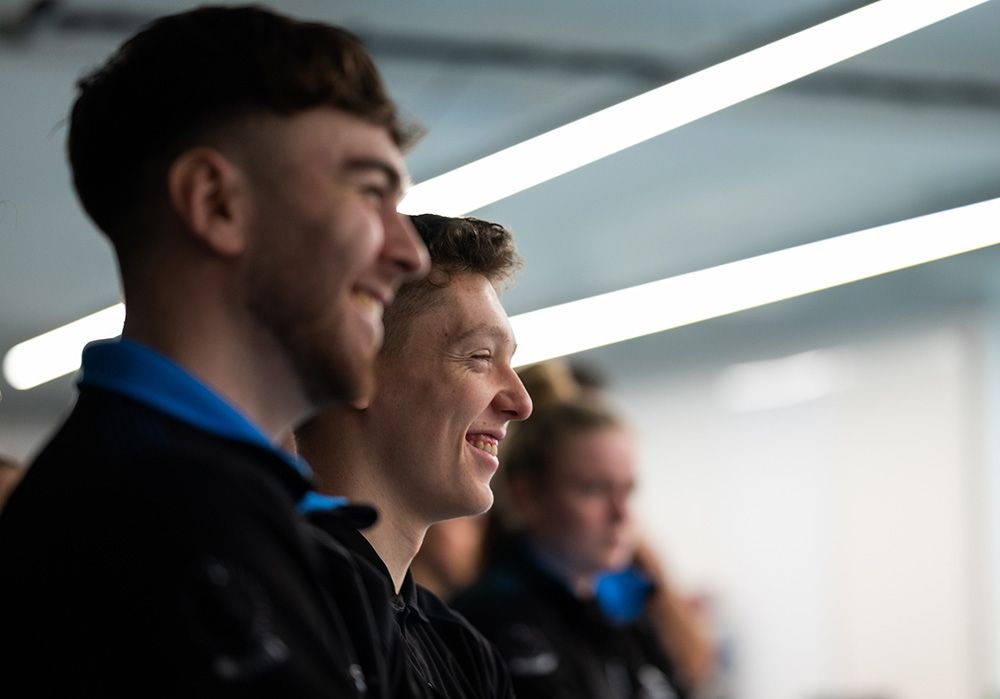 Sports Therapy students watching a demonstration and smiling