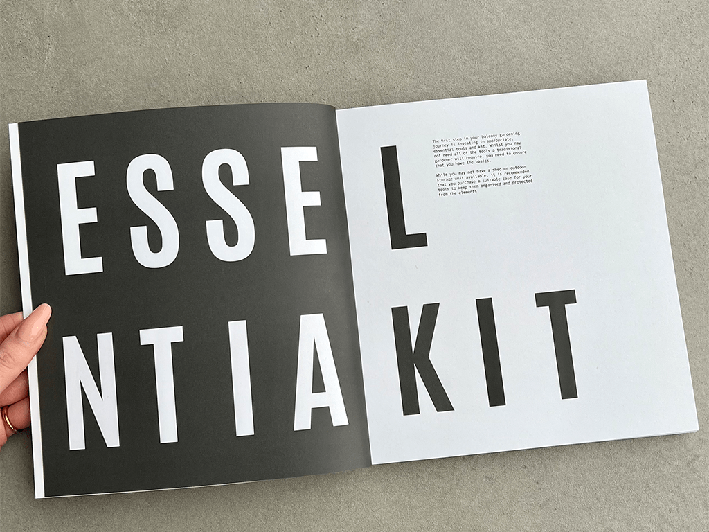 An open squared book with text which reads "Essential Kit".