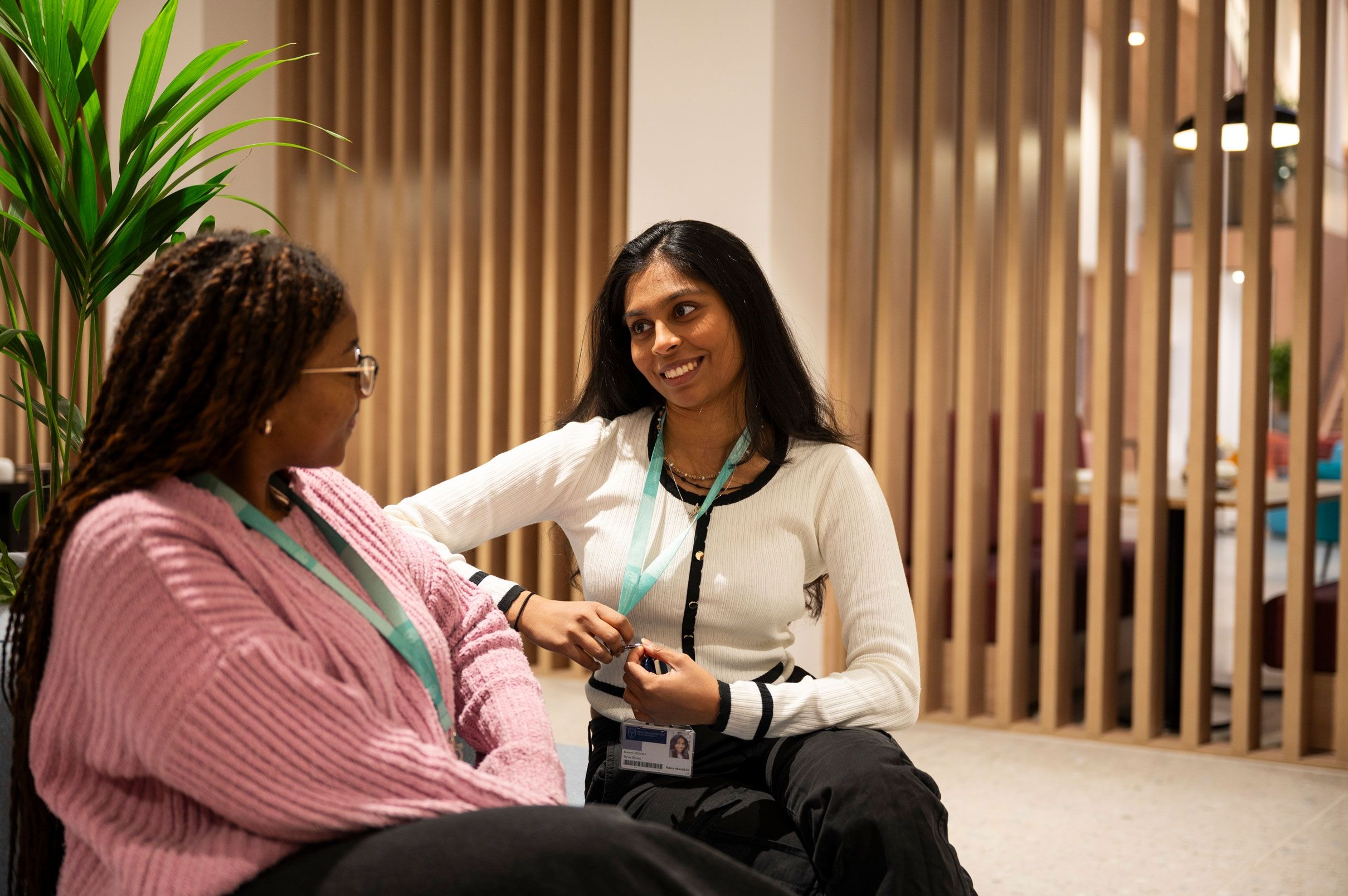 Two students chatting in the Atrium