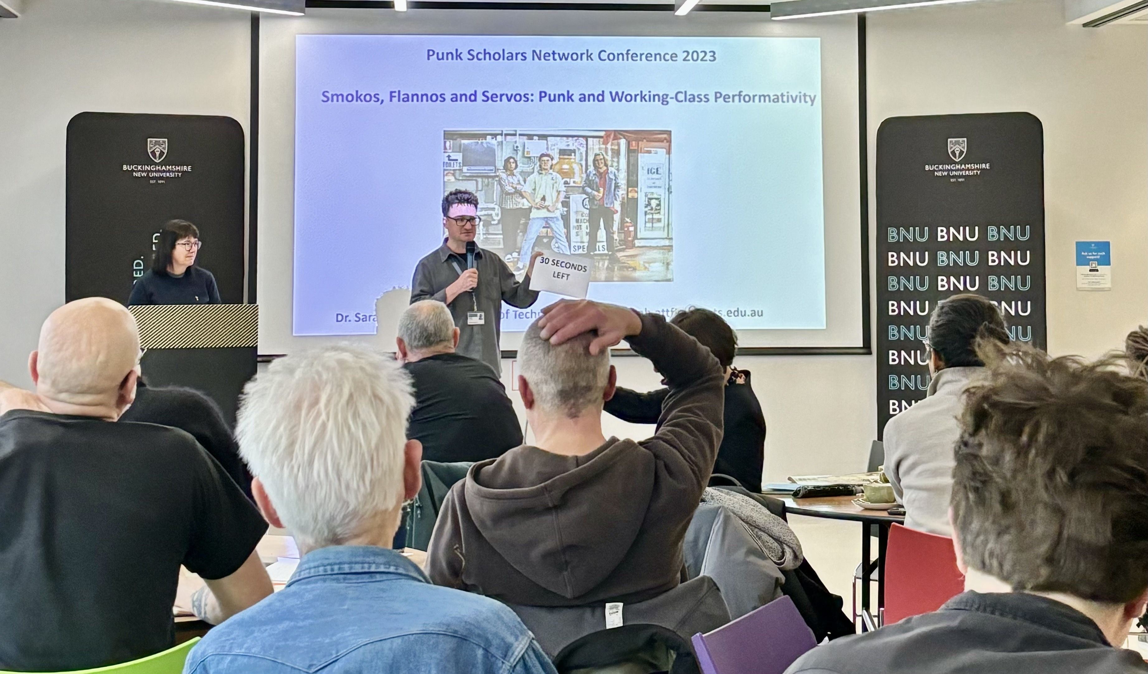 Paul Fields delivers presentation to attendees at Punk Scholars conference 