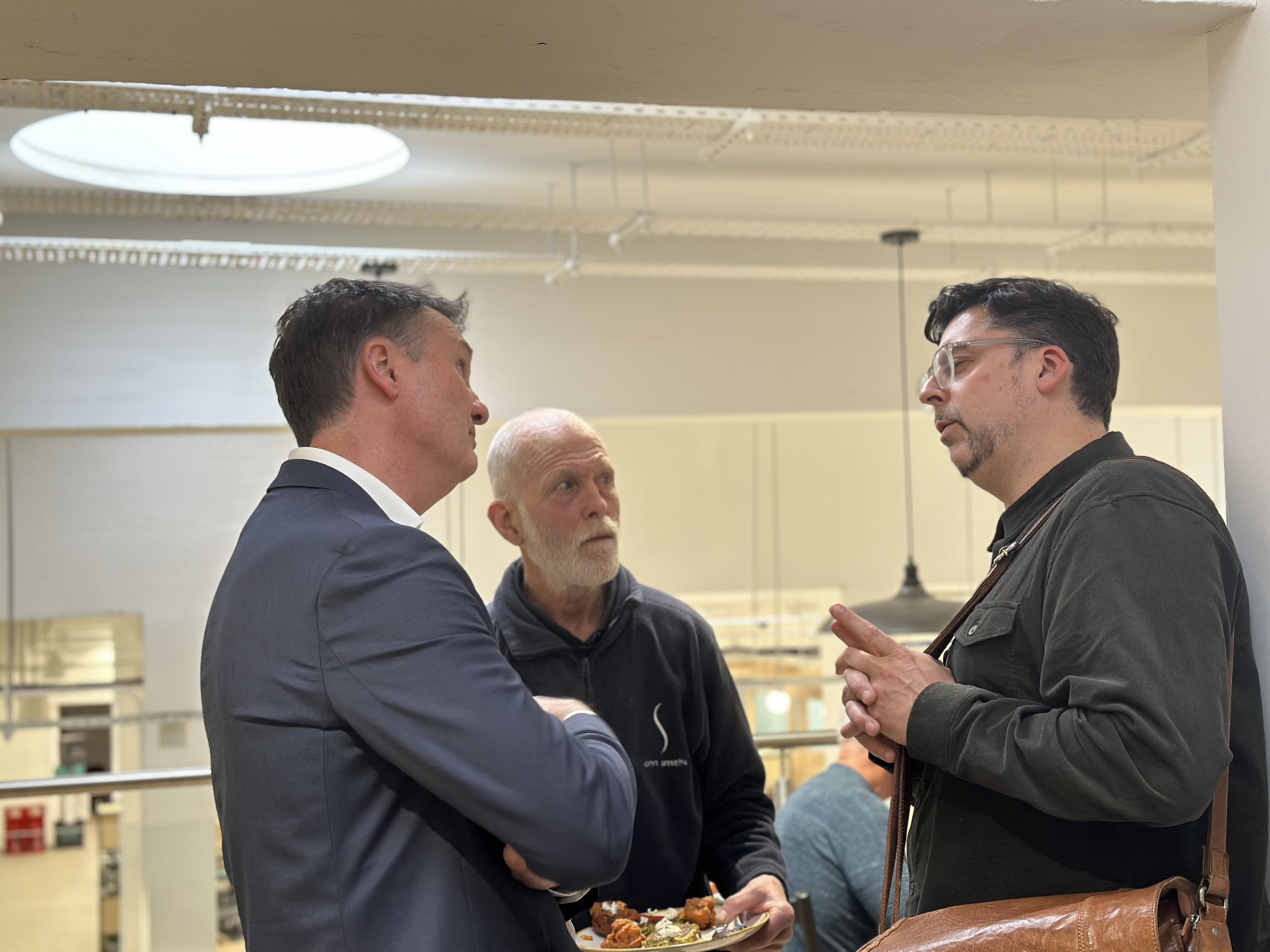 Paul Morgan talks to colleagues at drinks reception