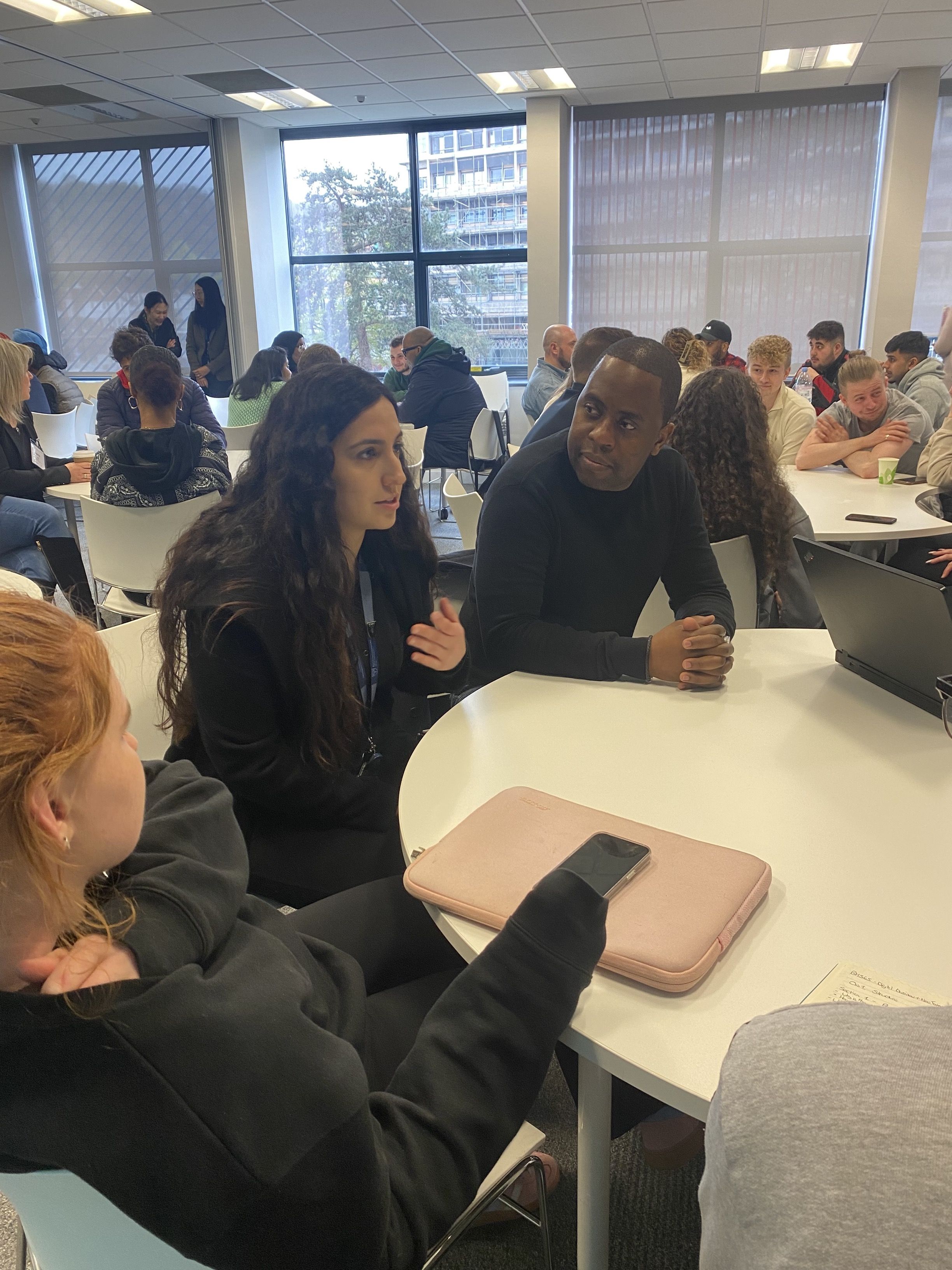 GTA Nasifa Ahmadi and Associate Lecturer Theo Mukamuri talking with students