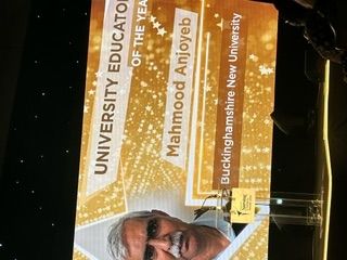 Display shows 'University Educator of the Year: Mahmood Anjoyeb'