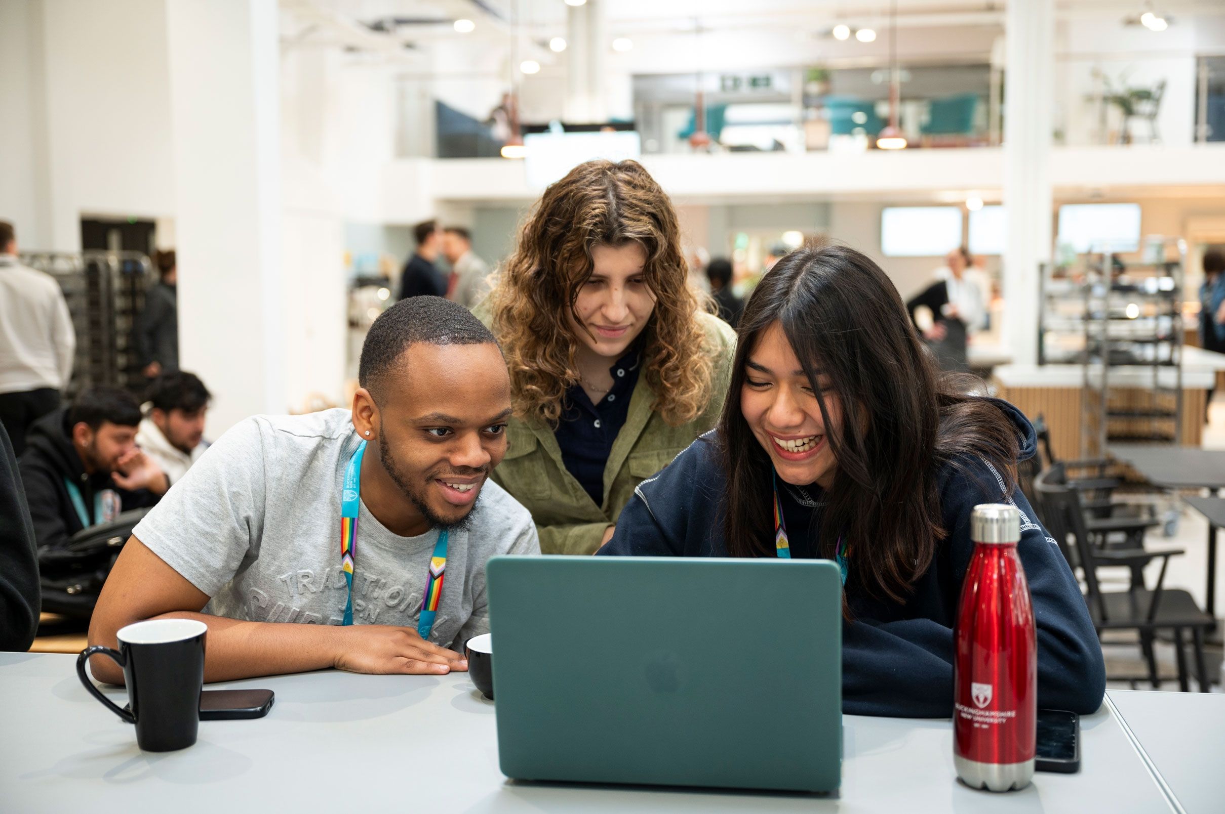 Students gathered together around a laptop