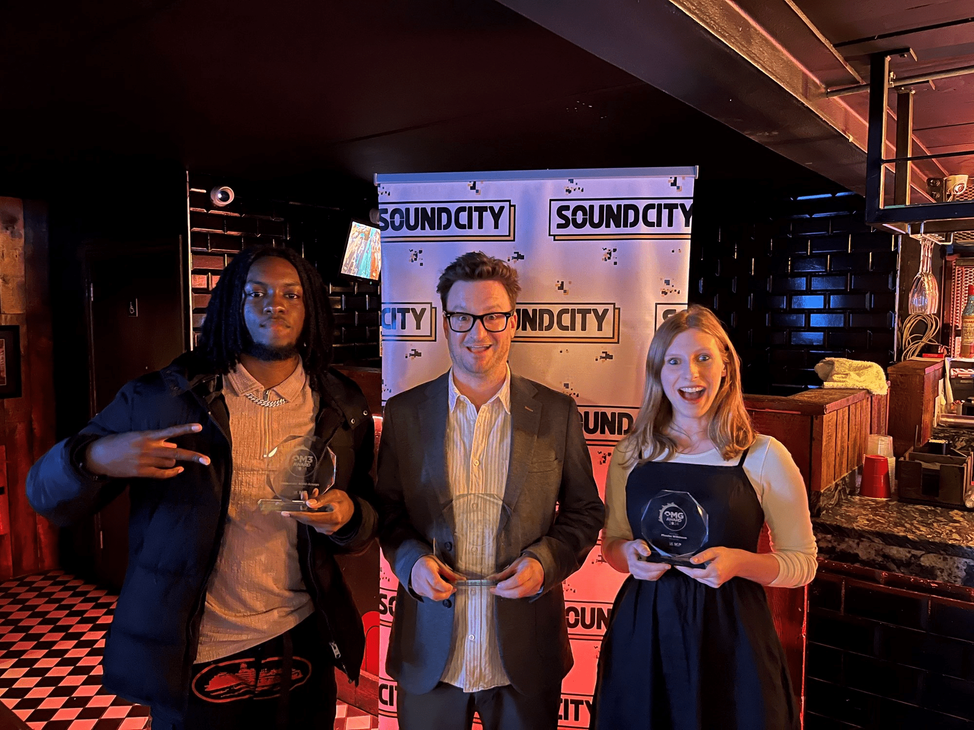 Emmanuel Alabi-Araoye, Paul Fields and Phoebe Wilkinson hold their trophies