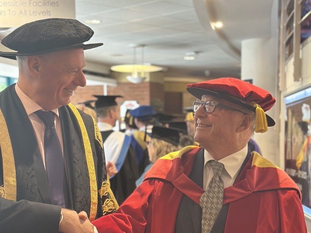 Professor Nick Braisby shakes hands with Phil Dudderidge OBE