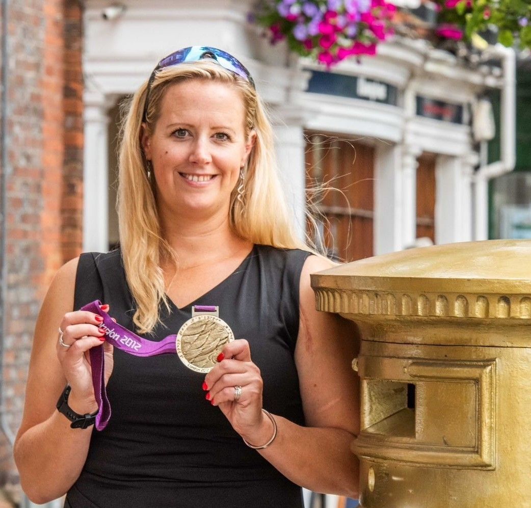 Naomi Riches MBE holds her Gold medal from the Paralympics 2012