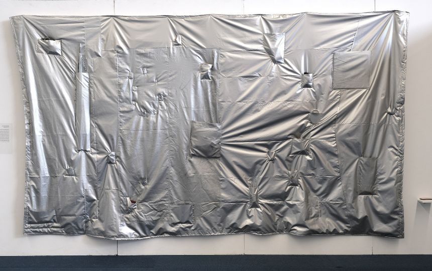 A silver sheet moulded onto a wall.