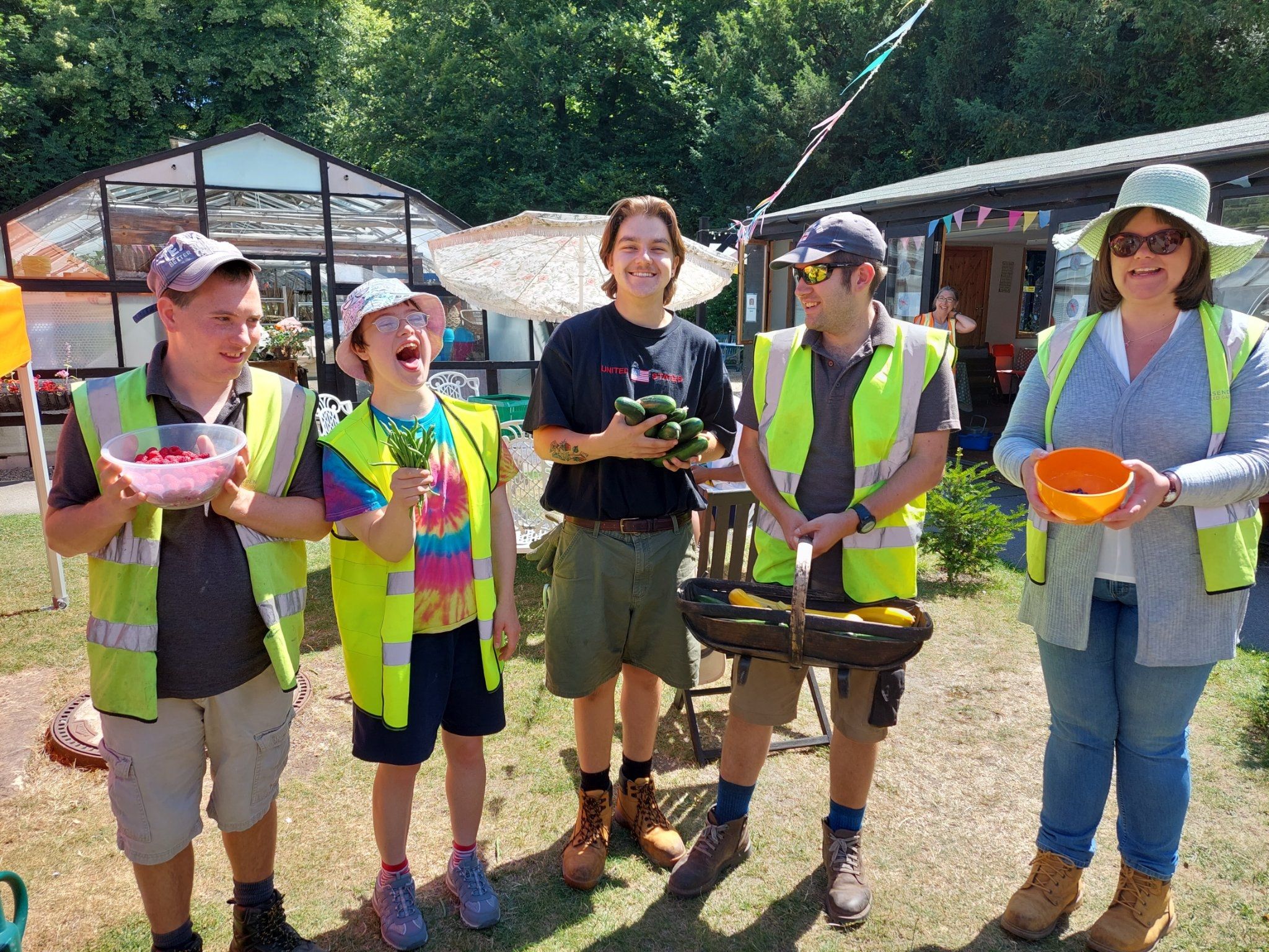 Five people hold the produce grown at Missenden Walled Garden