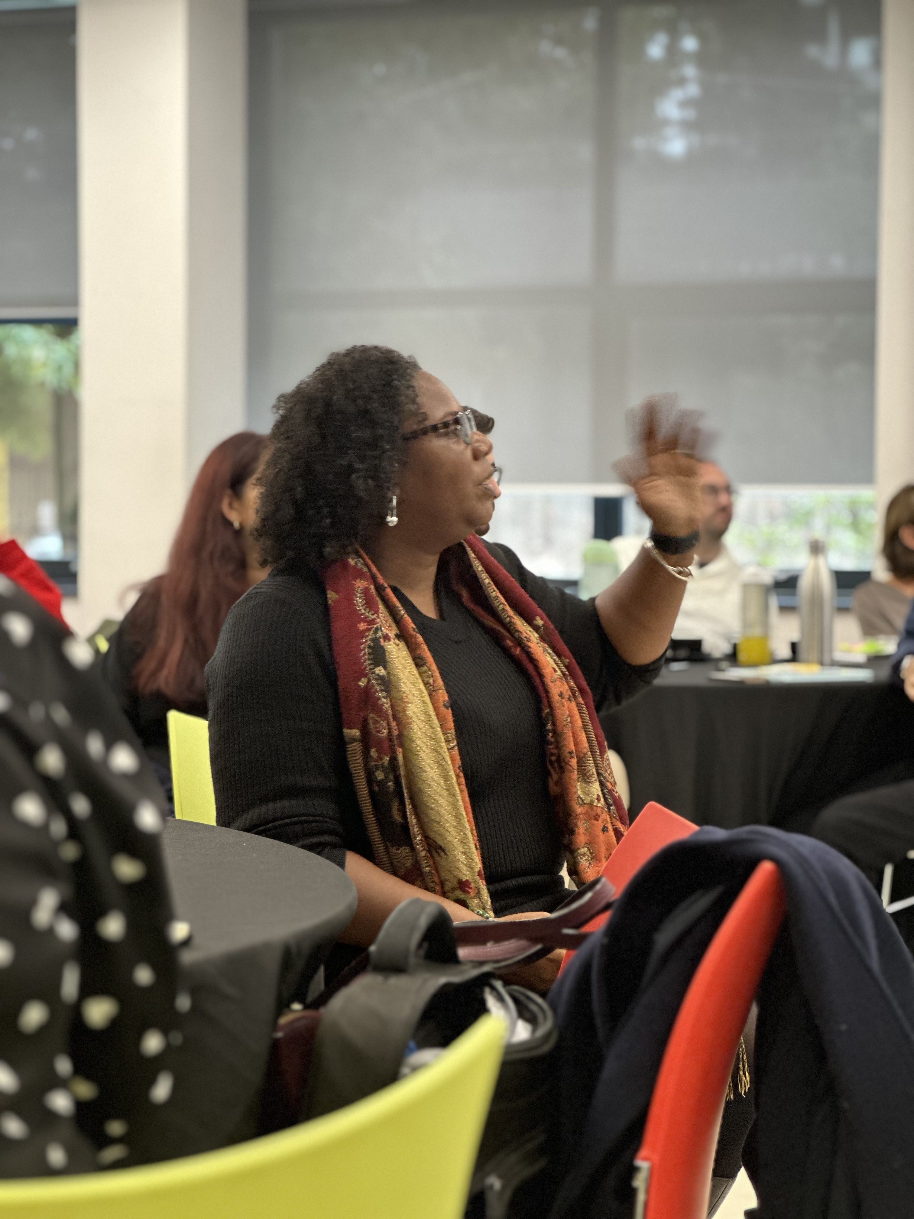 Aisha Richards give presentation to audience at inclusive leadership conference