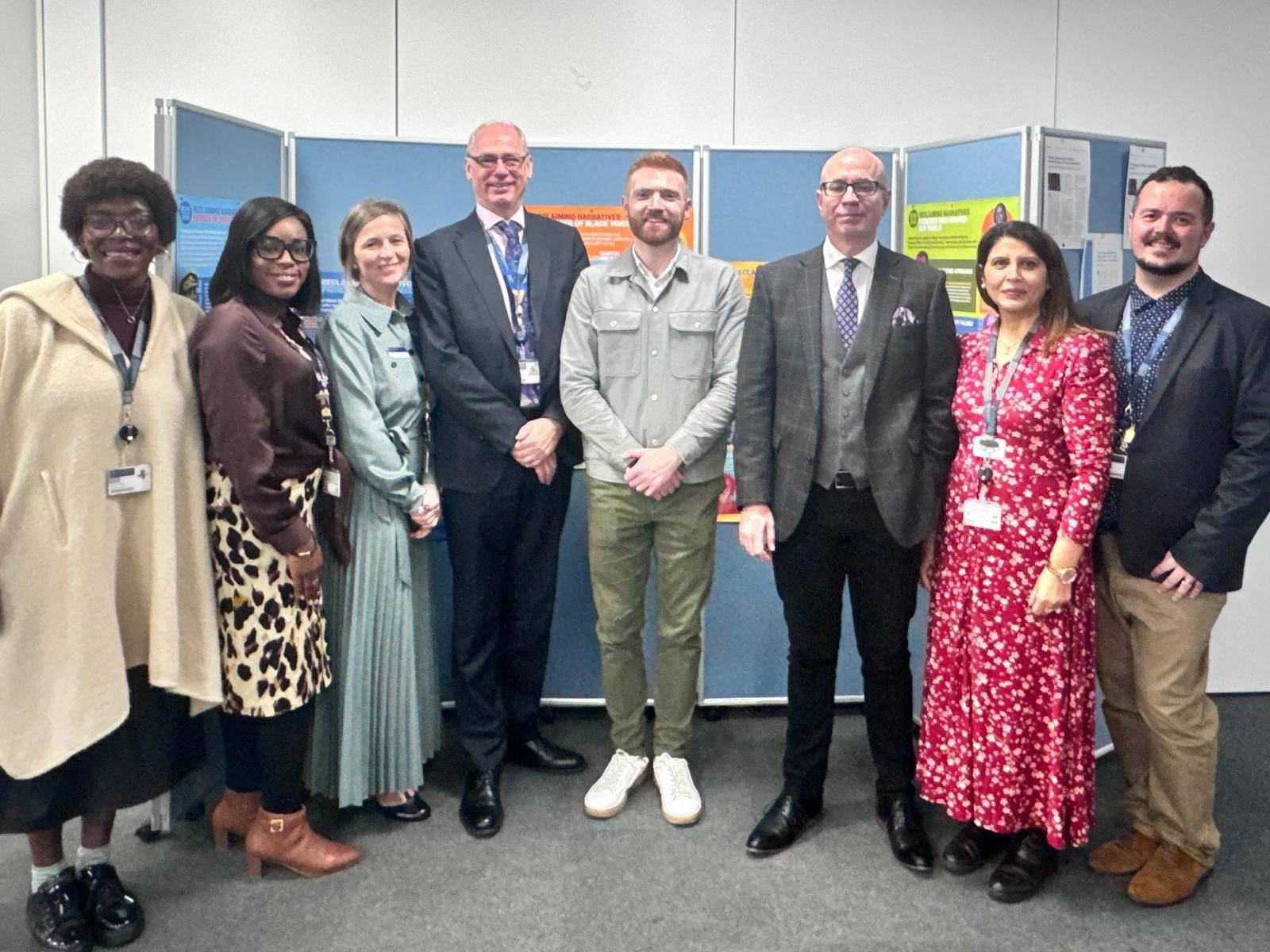 Group of men and women standing together and smiling
