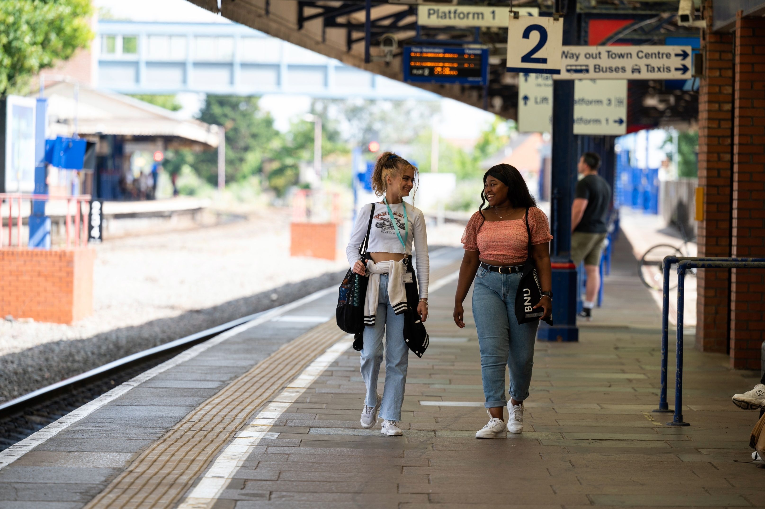 Two students walking in the train station