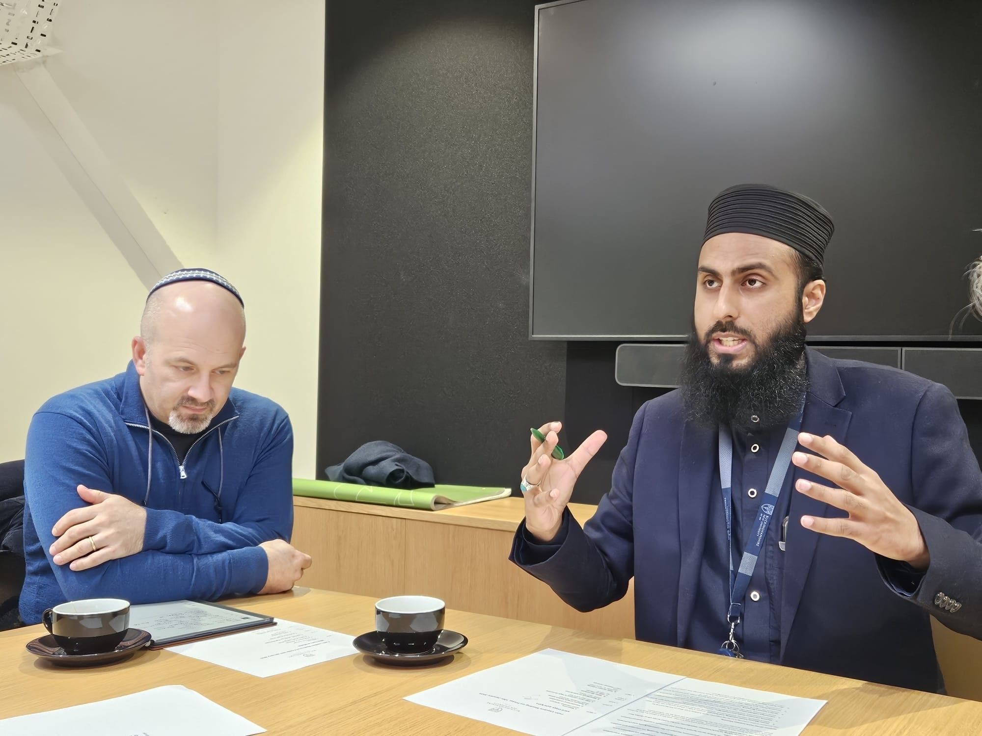 An imam speaking animatedly 