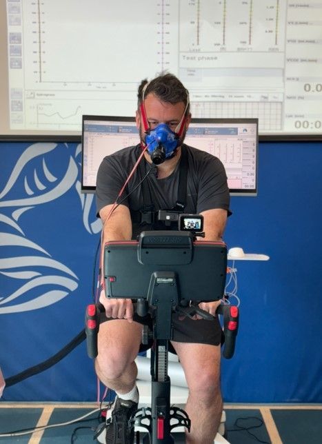 Man with a VO2 mask on and on an exercise bike