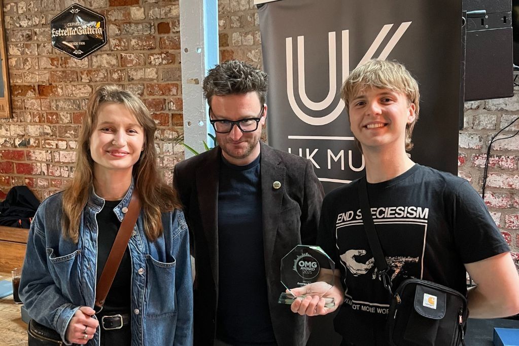 Two BNU students stood either side of Paul Fields, a lecturer whilst at the UK Music Awards.
