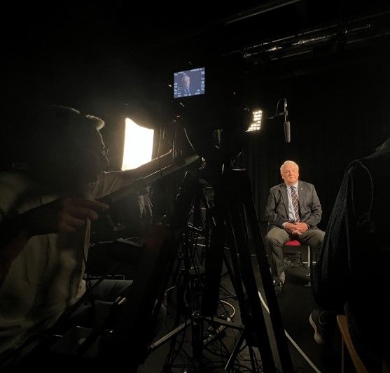 Man sat in front of a camera