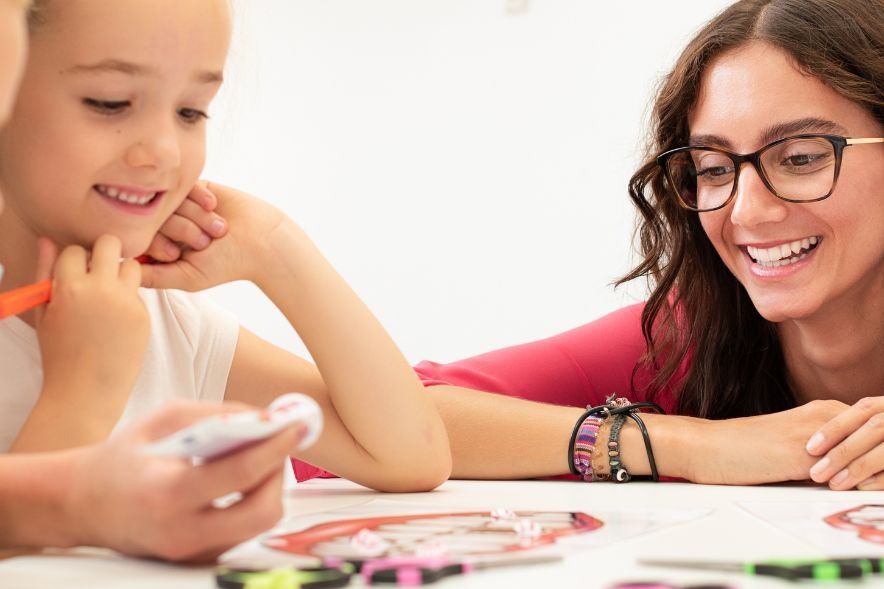 Occupational Therapist supporting a young child through play therapy.